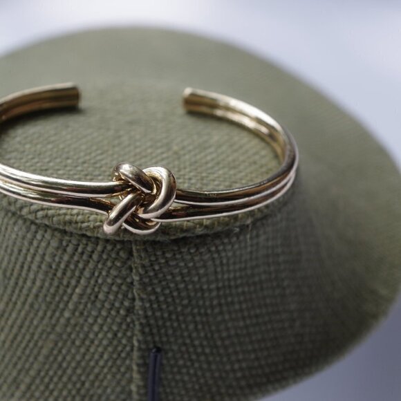 Women`s gold tone knot cuff bracelet. 2 1/2in. ID - Picture 3 of 5